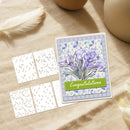 Greeting card with purple crocus design and 'Congratulations' text on a beige surface with decorative elements.