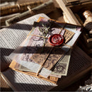 Decorative envelope with wax seal on top of an open book