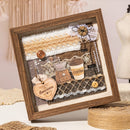 Decorative shadow box with coffee-themed elements and wooden frame.