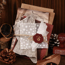 Collection of vintage-style stationery items with a star-patterned envelope and wax seal on a rustic background.