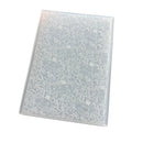 A clear plastic sheet containing embossed white cake-themed illustrations, shown at an angle on a plain white background.