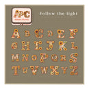Decorative alphabet set with floral designs on a green background, featuring the text 'Follow the light'.