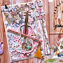 Decorative paper with musical notes, flowers, and tassels on a wooden surface.
