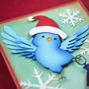 Blue bird with a Santa hat on a Christmas-themed card with snowflakes.