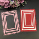 Two decorative paper frames, one pink and one red, on a dark surface with flowers in the background.