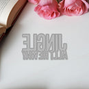 Decorative cutout letters spelling 'All the light ways' on a white surface with pink roses.