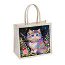 Beige tote bag with a colorful cat illustration on a white background