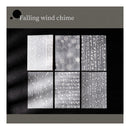 Falling wind chime design with decorative patterns on a black background