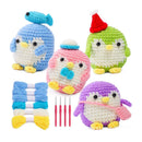 Set of colorful crocheted penguin toys with yarn and hooks on a white background