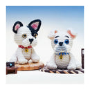 Two crochet dogs with colorful collars on a white background