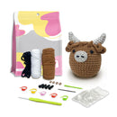 Crochet kit with yarn, hooks, and a partially completed crochet animal on a white background
