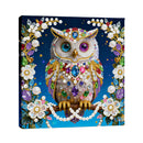 Decorative owl painting with colorful beads and pearls on a blue background