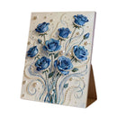 Decorative card with blue roses and pearls on a white background