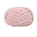 Pink knitted yarn ball on a white background