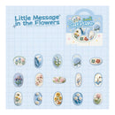 Packaging of 'Little Message in the Flowers' soft plush toy with floral designs on a blue grid background.