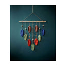 Colorful leaf-shaped hanging decoration on a teal background