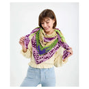 Woman wearing a colorful crocheted shawl on a white background