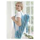 Woman holding a blue and black patterned yoga mat bag indoors.