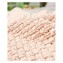 Close-up of a textured pink fabric with a blurred outdoor background