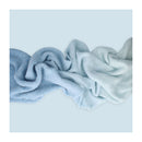 Light blue textured fabric on a light blue background