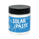 Jar of solar paste with blue label and black lid on white background