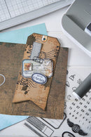 Decorative envelope with vintage design on a desk with crafting tools