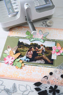 Scrapbooking project with photo of family, decorative elements, and crafting tools on a table.