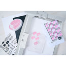 Set of rubber stamps with 'hello' text and a pink stamp pad on a white background