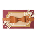 Brown bow tie on a decorative card with floral elements