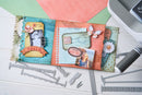 Decorative scrapbooking pages with embellishments on a white surface