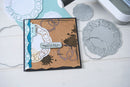 Handmade card with decorative elements on a white surface