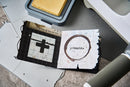 Stamps with grid, cross, and circle design on a textured surface