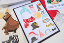 Sheet of birthday-themed cutouts with hats, scarves, and balloons on a white background.