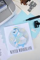Card with a polar bear illustration labeled 'Winter Wonderland' on a light blue background with stationery items.