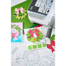 Card-making supplies including cut-out cards with wreaths and bows, a cutting machine, and tools on a white background.