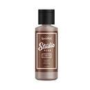 Brown bottle of Speedball Studio Plus ink on a white background