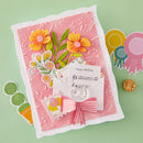 Handmade card with floral design, ribbon, and 'Happy Birthday' card on a green background