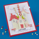 Handmade card with paper houses and a cat on a blue background