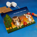 S'mores kit with cartoon bear and deer design on a blue background