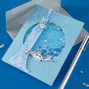 Blue graduation-themed card with decorative elements on a blue background