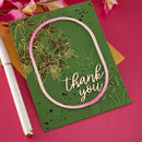 Green card with floral design and 'thank you' text on a pink background