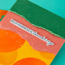 Colorful paper with 'Your kindness is touching' text on a teal background