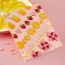 Decorative paper with colorful cutouts on a pink background