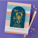 Scorpio zodiac card with decorative elements on a purple background