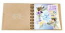 Open spiral-bound notebook with motivational quote and floral design on a white background
