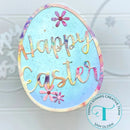 Easter egg-shaped card with 'Happy Easter' text and flowers on a light blue background, featuring the Trinity Stamps Creative Team logo.
