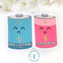 Two battery-shaped containers with faces, one blue and one pink, on a white background.