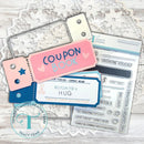 Set of stamping tools and dies for creating coupons and vouchers on a wooden surface.