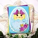 Card with a chick design and flowers on a textured surface