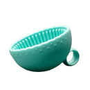 Turquoise silicone cup with handle on a white background